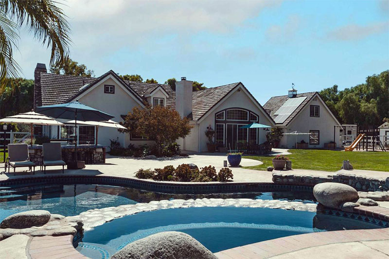 A beautiful property overlooks an inviting swimming pool.