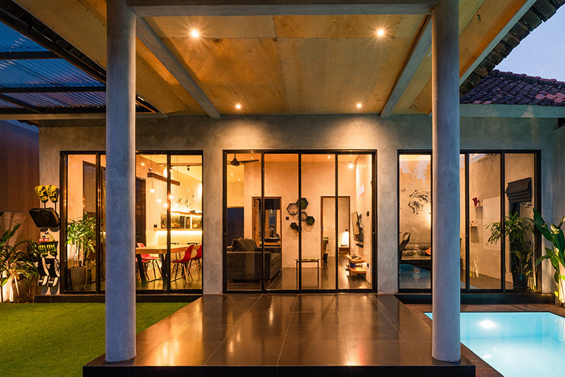 Lights shimmer and illuminate the entryway to an opulent home.